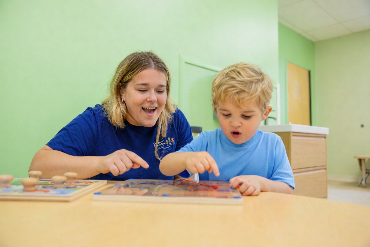 Therapist and child working on puzzle activity